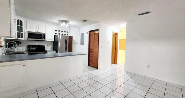a kitchen with stainless steel appliances a refrigerator and a sink