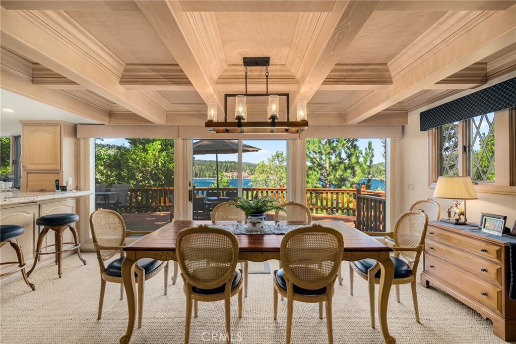 a view of a dining room with furniture wooden floor and chandelier