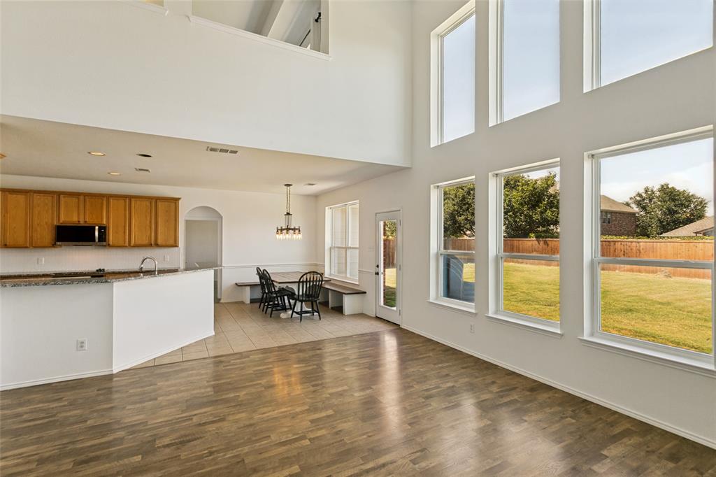 4107 Waverly Road Corinth, TX 76208 - Photo 8 of 30 The captivating wall of windows in the family room offers a nice view of the large backyard and allows for tons of natural light into this home.