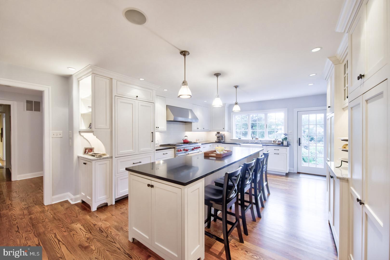 228 South Fairfield Road Devon, PA 19333 - Photo 22 of 61 a kitchen with stainless steel appliances kitchen island a table chairs refrigerator and sink