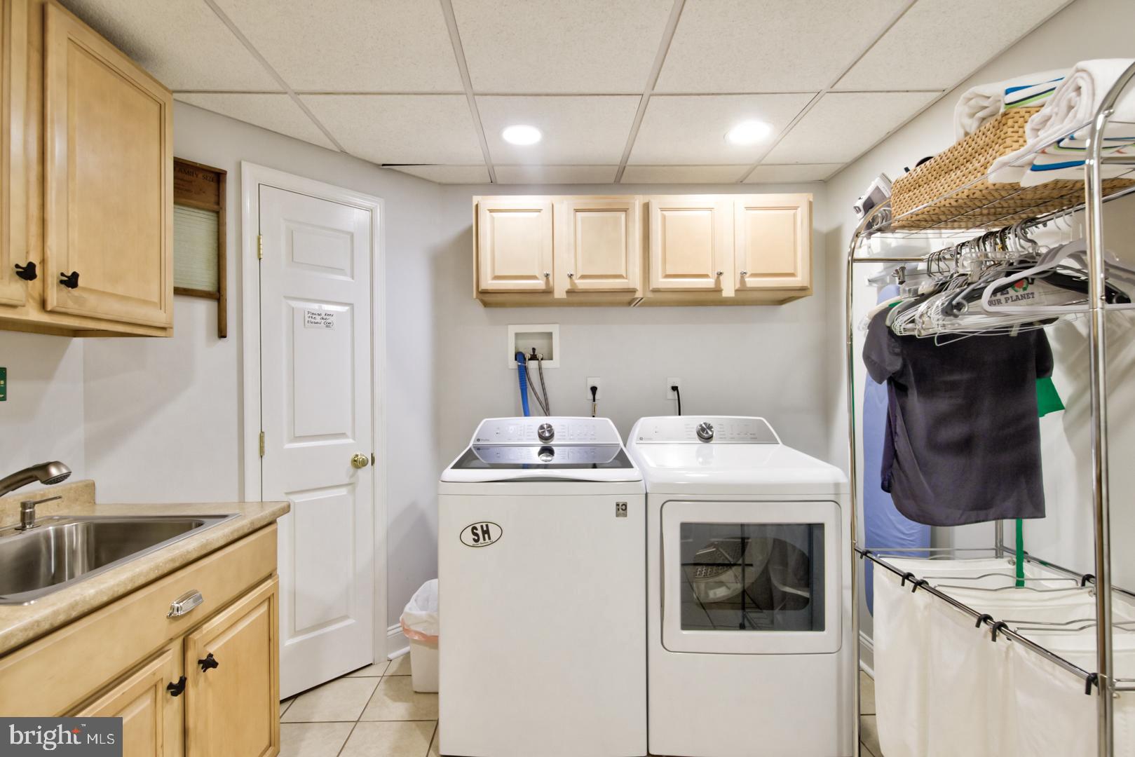 228 South Fairfield Road Devon, PA 19333 - Photo 60 of 61 a utility room with cabinets dryer and washer