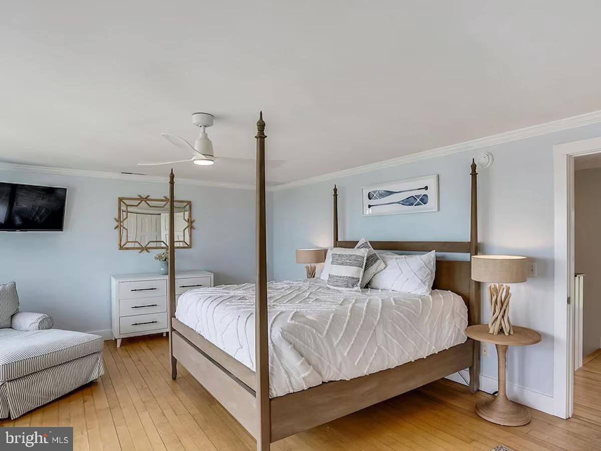 21642 Chicken Point Road Tilghman, MD 21671 - Photo 25 of 63 a bedroom with a bed and a couch