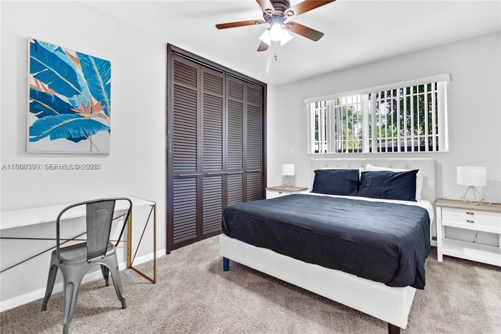 460 Northwest 88th Terrace El Portal, FL 33150 - Photo 11 of 20 a bedroom with a bed and a chandelier