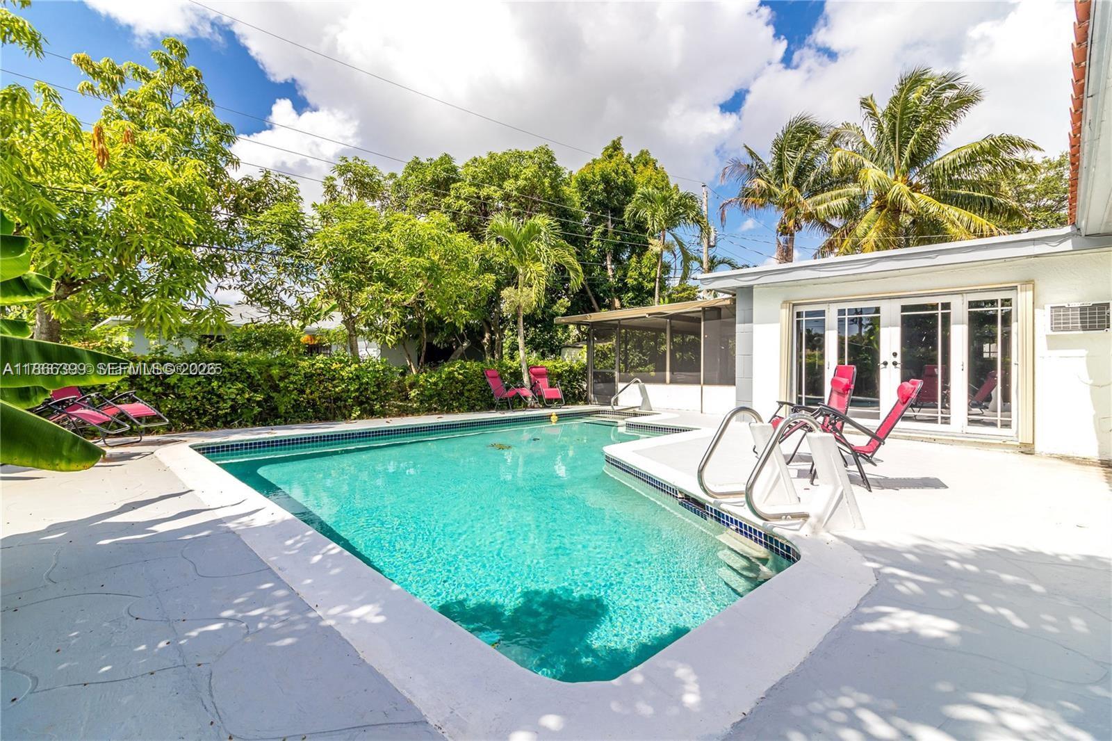 460 Northwest 88th Terrace El Portal, FL 33150 - Photo 19 of 20 a view of a backyard with a patio and swimming pool