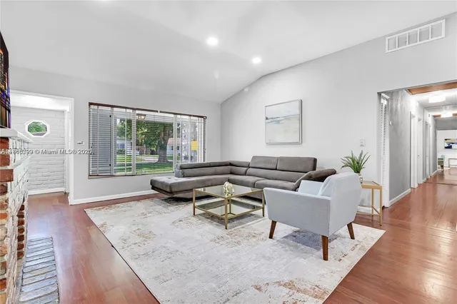 a living room with furniture and wooden floor