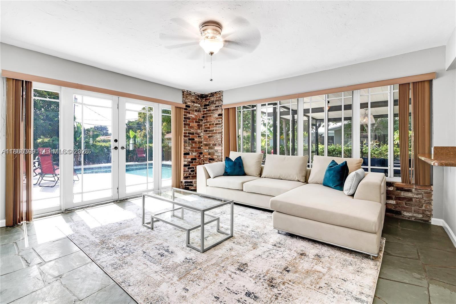 460 Northwest 88th Terrace El Portal, FL 33150 - Photo 6 of 20 a living room with furniture and a large window