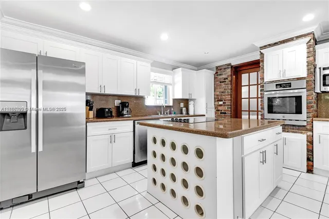 a kitchen with stainless steel appliances a refrigerator sink stove microwave and cabinets
