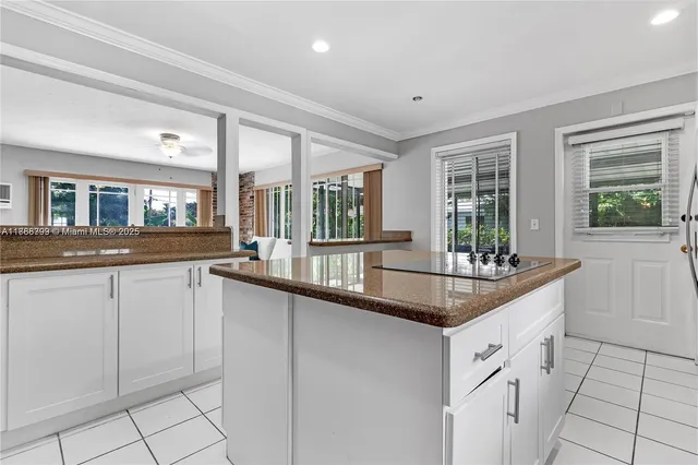 a kitchen with granite countertop a sink and cabinets