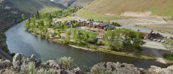 an aerial view of a house with a yard and lake view