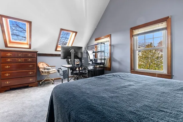 a bed room with a bed and a window