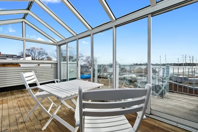 a view of a balcony with table and chairs