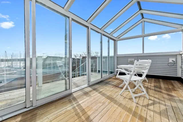 a view of a patio with a table and chairs under an umbrella
