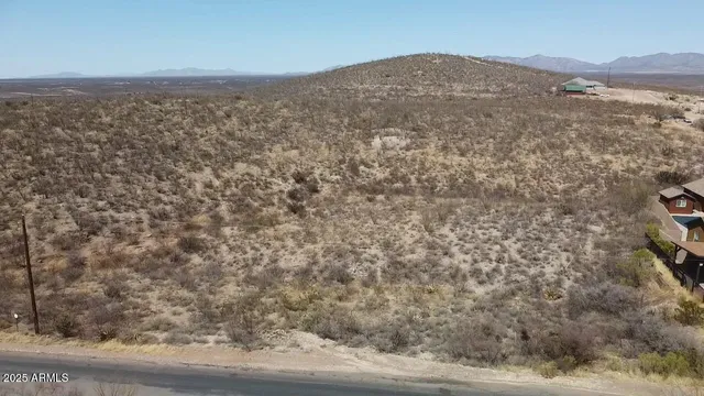 a view of a field with mountains in the background
