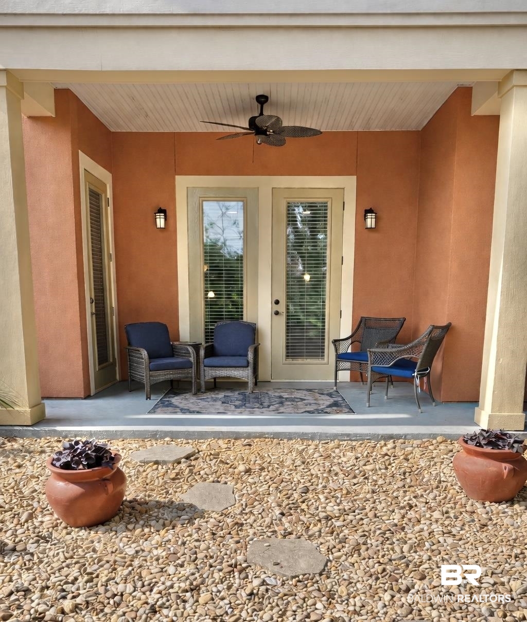 1430 Regency Road, Unit C101 Gulf Shores, AL 36542 - Photo 19 of 32 Entrance to property with a ceiling fan, a patio area, and stucco siding