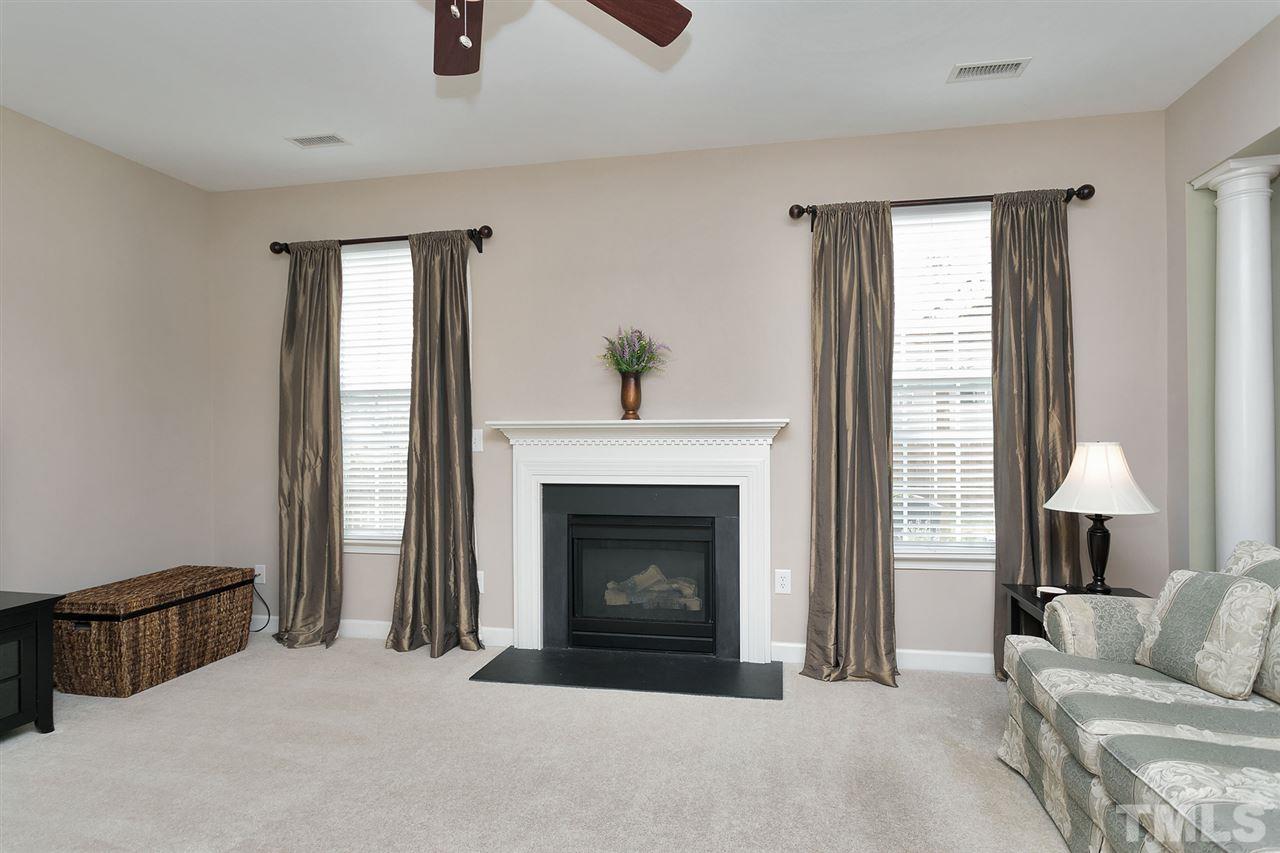 5136 Holly Ridge Farm Road Raleigh, NC 27616 - Photo 11 of 25 a living room with furniture and a fireplace