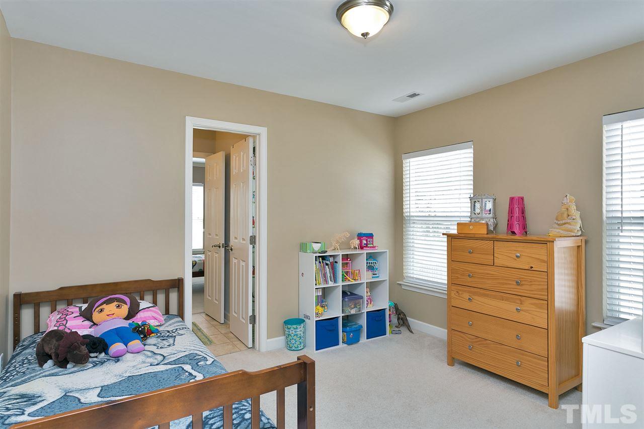 5136 Holly Ridge Farm Road Raleigh, NC 27616 - Photo 14 of 25 a bed room with a bed and a dresser