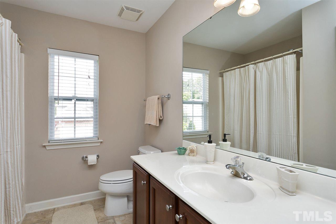 5136 Holly Ridge Farm Road Raleigh, NC 27616 - Photo 16 of 25 a bathroom with a sink toilet and vanity