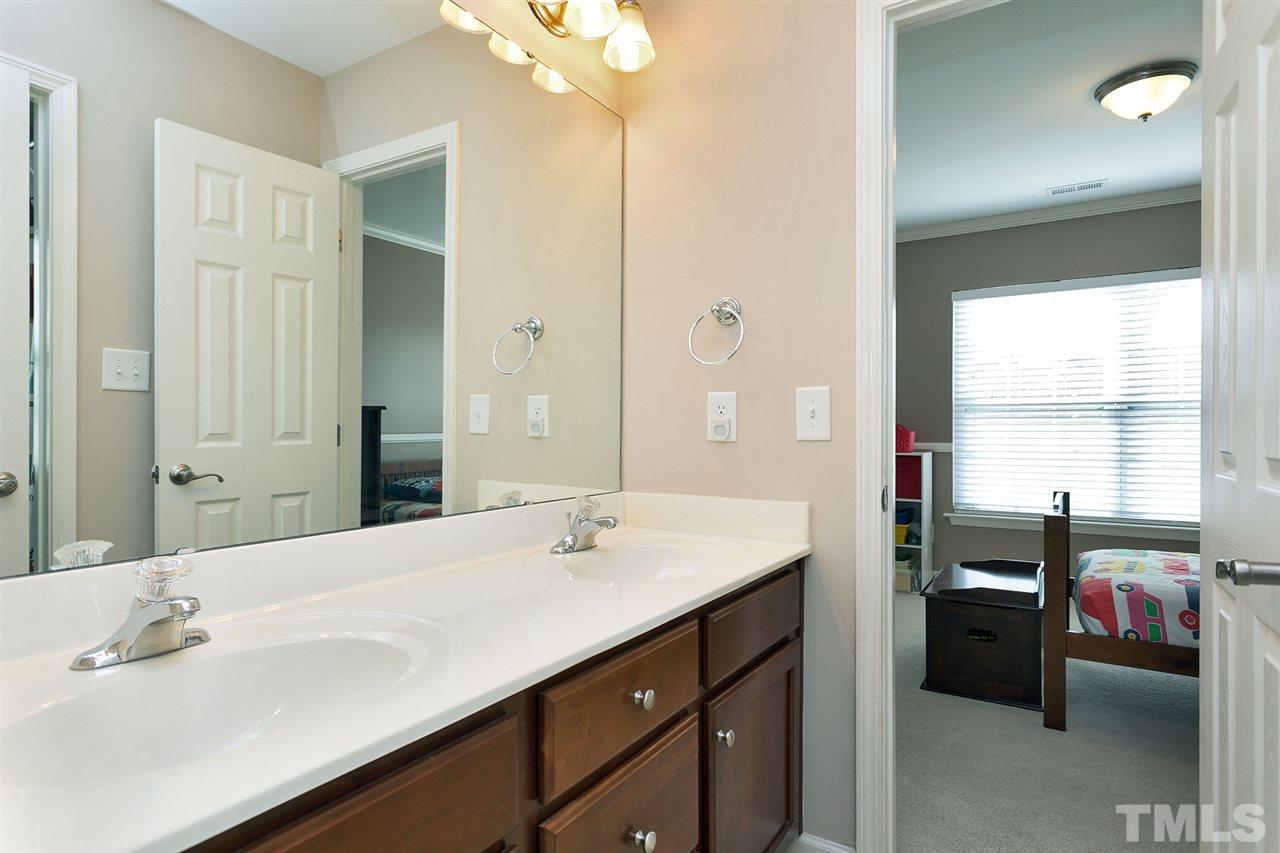 5136 Holly Ridge Farm Road Raleigh, NC 27616 - Photo 17 of 25 a en suite bathroom with a double vanity sink a mirror and a shower