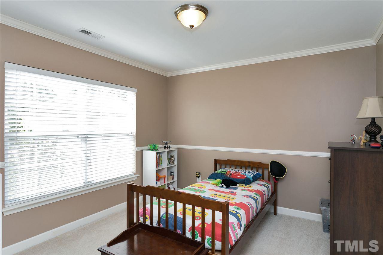 5136 Holly Ridge Farm Road Raleigh, NC 27616 - Photo 18 of 25 a bedroom with a bed and a window