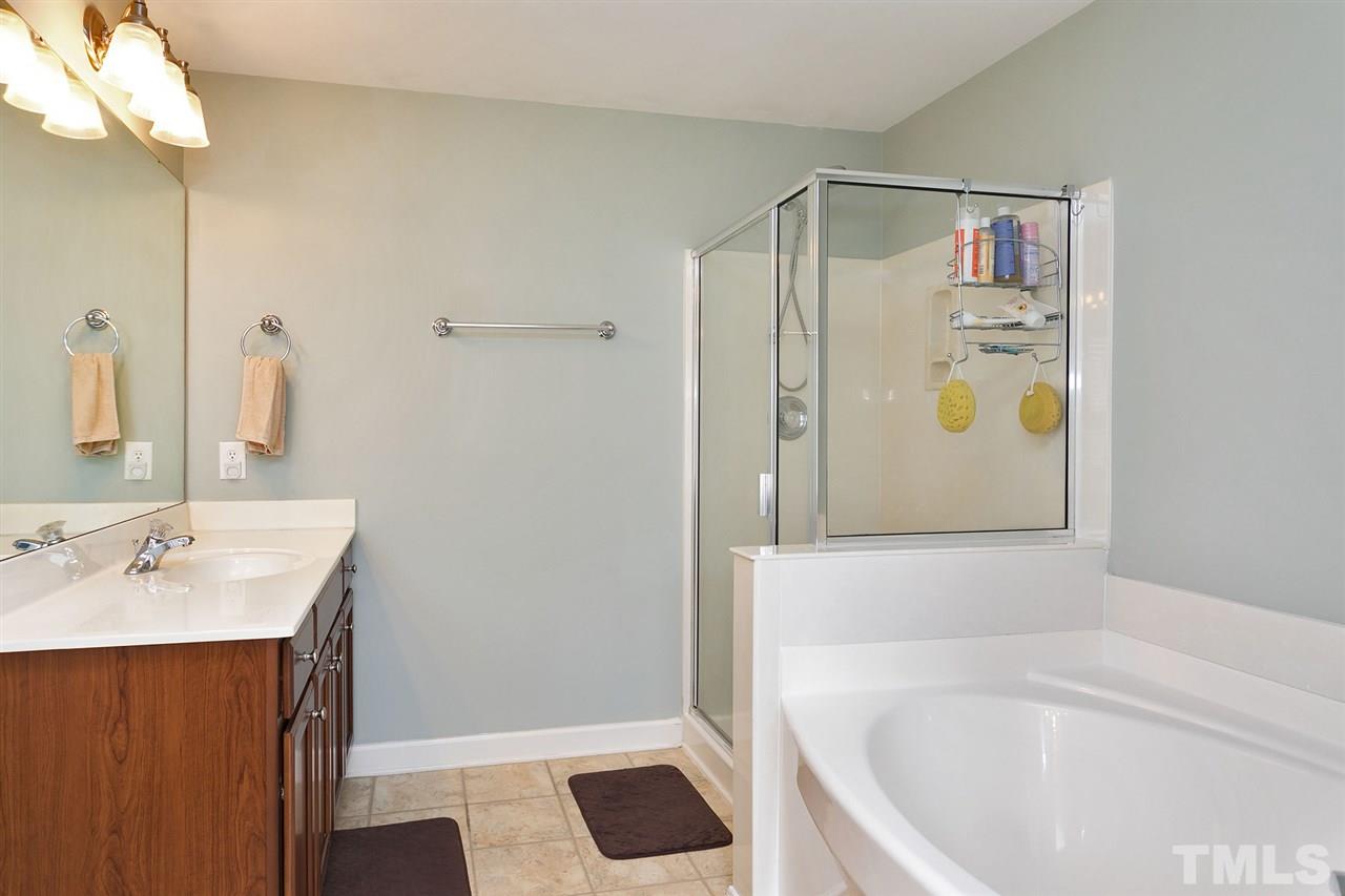 5136 Holly Ridge Farm Road Raleigh, NC 27616 - Photo 20 of 25 a bathroom with a tub sink and mirror