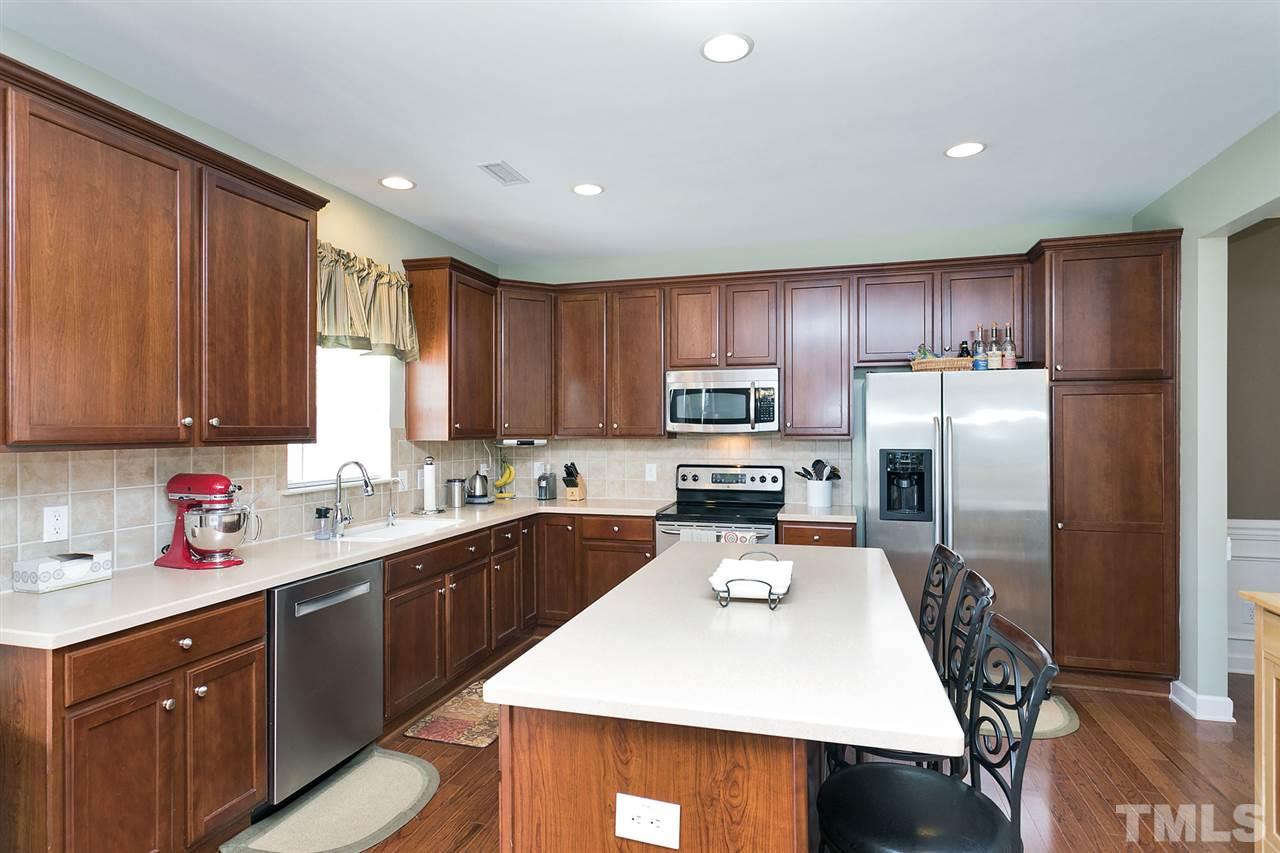 5136 Holly Ridge Farm Road Raleigh, NC 27616 - Photo 2 of 25 a kitchen with kitchen island a sink appliances and cabinets