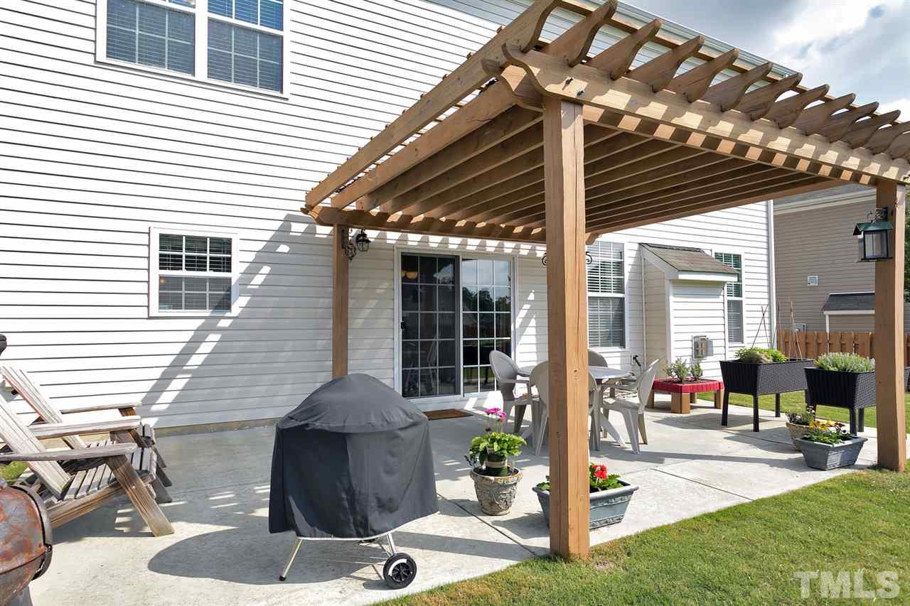 5136 Holly Ridge Farm Road Raleigh, NC 27616 - Photo 23 of 25 a view of a patio with table and chairs and potted plants
