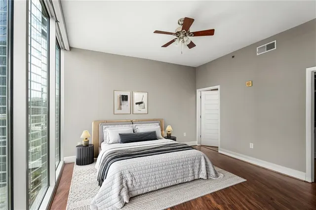 a bedroom with a large bed and a chandelier