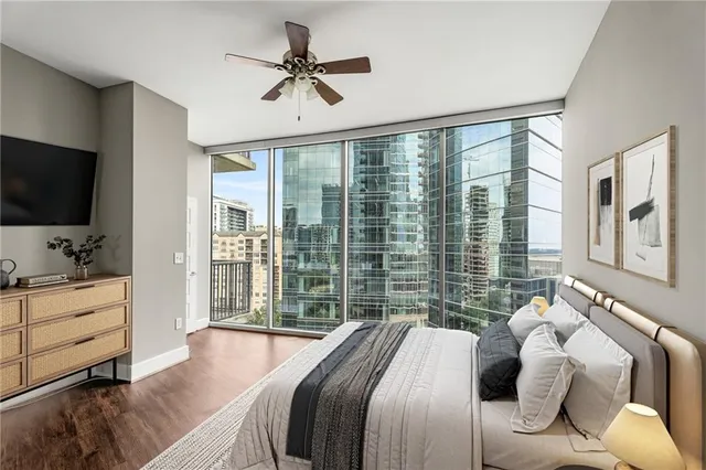 a bedroom with a large bed and a flat screen tv