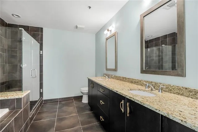 a bathroom with a granite countertop sink mirror and double