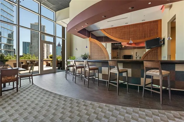 a dining room with furniture a large window and a rug