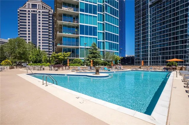 a view of swimming pool with outdoor seating and plants