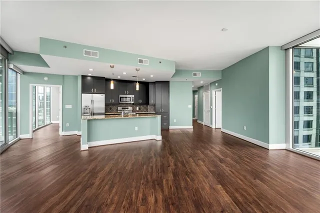 a view of kitchen and hall with wooden floor