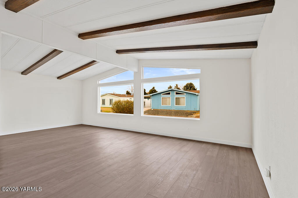 3701 Gun Club Road, Unit 45 Yakima, WA 98901 - Photo 11 of 20 a view of an empty room with wooden floor and windows