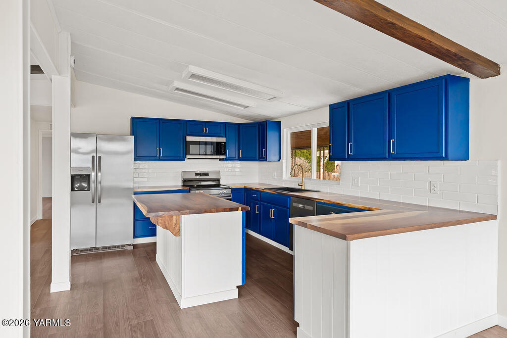 3701 Gun Club Road, Unit 45 Yakima, WA 98901 - Photo 2 of 20 a kitchen with stainless steel appliances a sink a stove a refrigerator cabinets and a counter top space