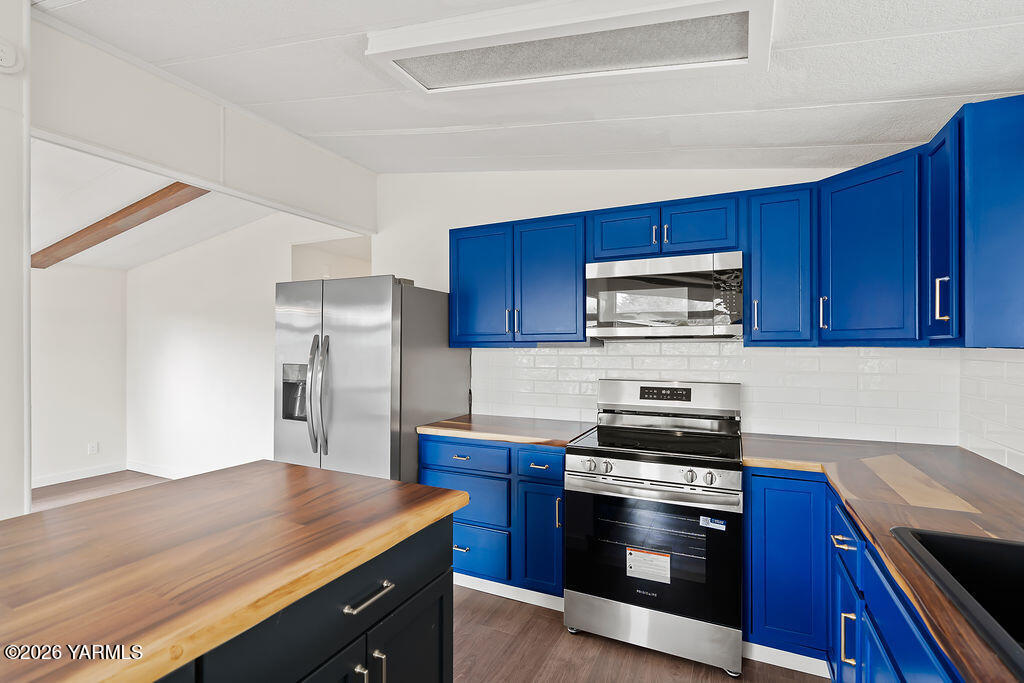 3701 Gun Club Road, Unit 45 Yakima, WA 98901 - Photo 6 of 20 a kitchen with stainless steel appliances and wooden cabinets