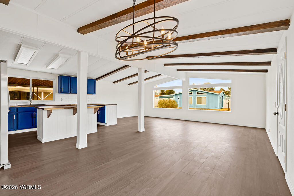 3701 Gun Club Road, Unit 45 Yakima, WA 98901 - Photo 8 of 20 a view of an empty room with kitchen and wooden floor