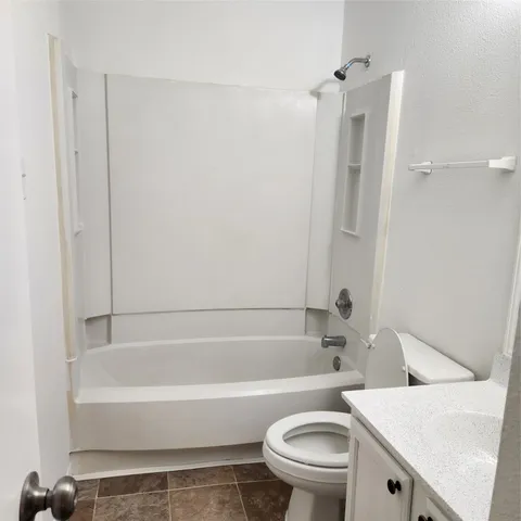 a bathroom with a sink a toilet and a bathtub