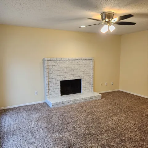 a view of an empty room with a fireplace