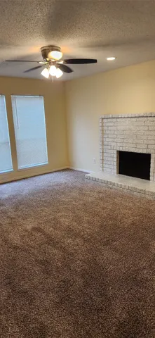 a view of an empty room with a fireplace