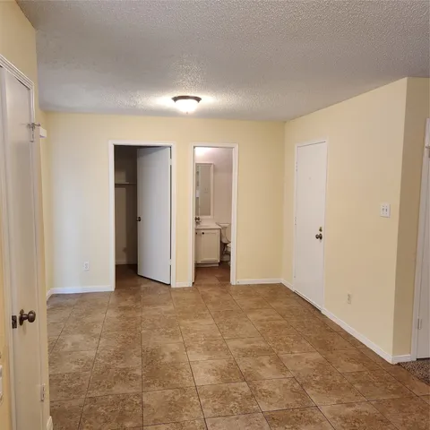 a view of an empty room and a window