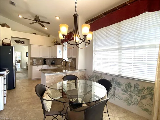a kitchen with dining table and chairs