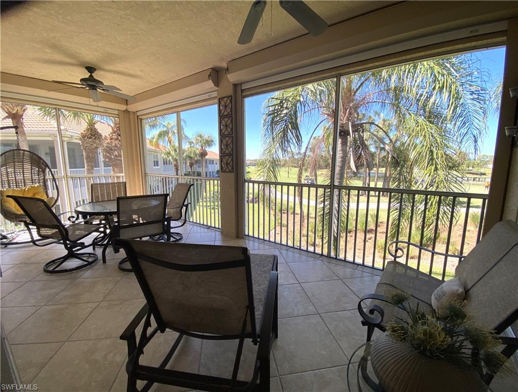 1570 Winding Oaks Way, Unit 201 Naples, FL 34109 - Photo 16 of 35 a living room with furniture and floor to ceiling windows