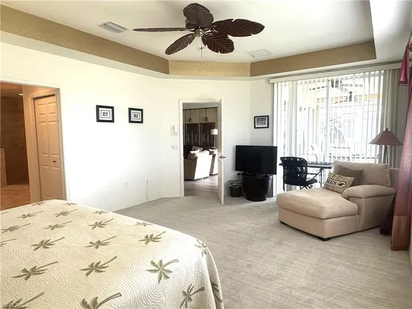 a spacious bedroom with a bed and couch