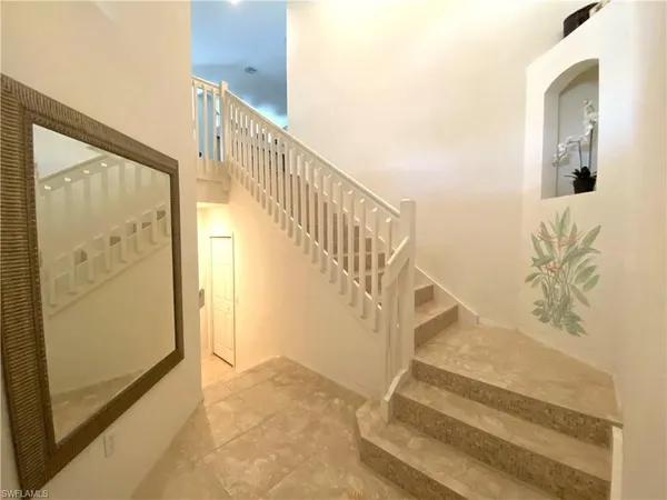 a view of staircase with white walls and a next to a window
