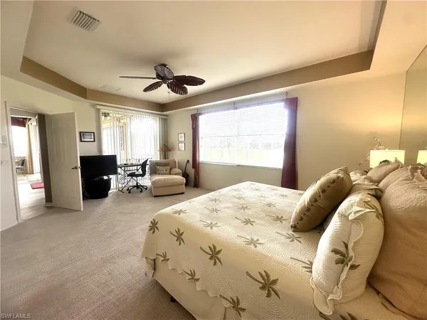 a bedroom with bed and a chandelier