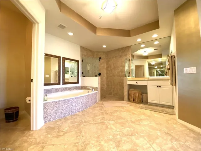 a bedroom with a bed flat screen tv and a window