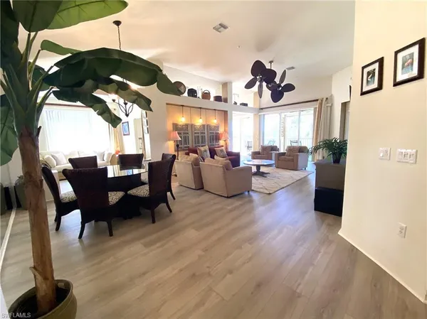 a view of a dining room with furniture window and wooden floor
