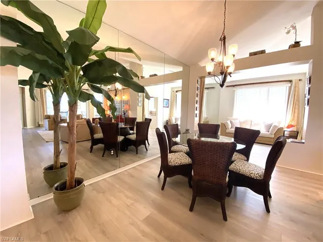 a view of a dining room with furniture and chandelier