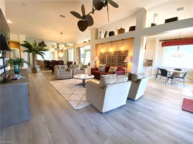 a living room with fireplace furniture and a large window