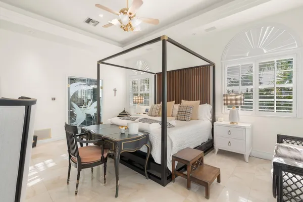 a bedroom with a bed and a window